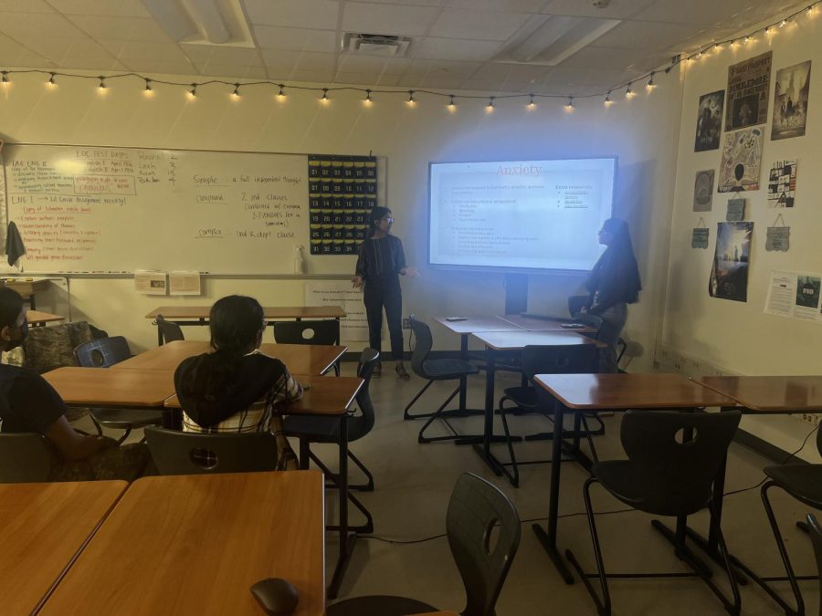 Co-Presidents Rutu Rupurel '25 and Mishree Narasaiah '25 present their slideshow about anxiety, the focus of the April meeting. 