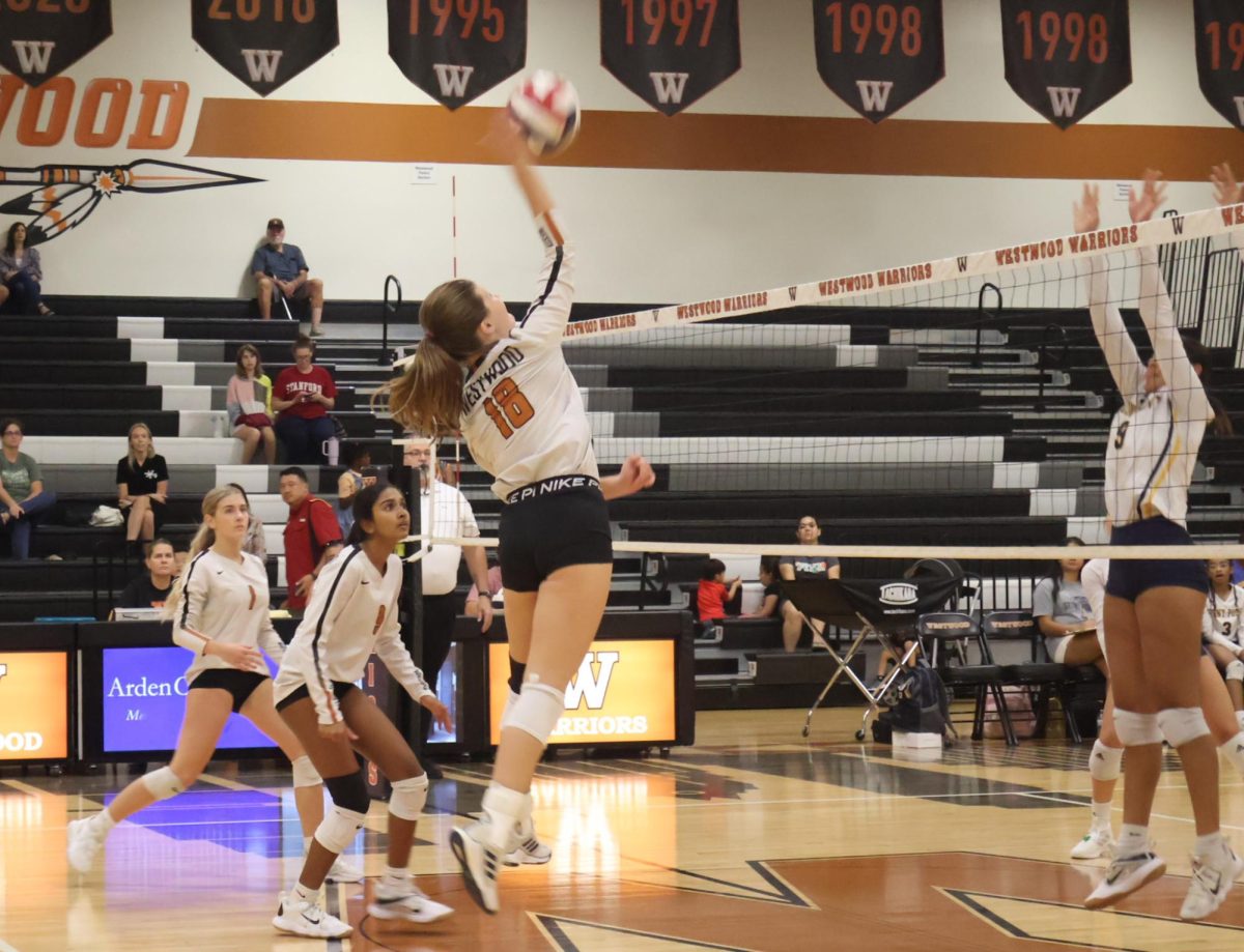 Lila Wellington '27 hits the ball over the net during the second set. The Warriors were down and doing everything they could to keep the score from getting away from them more. 