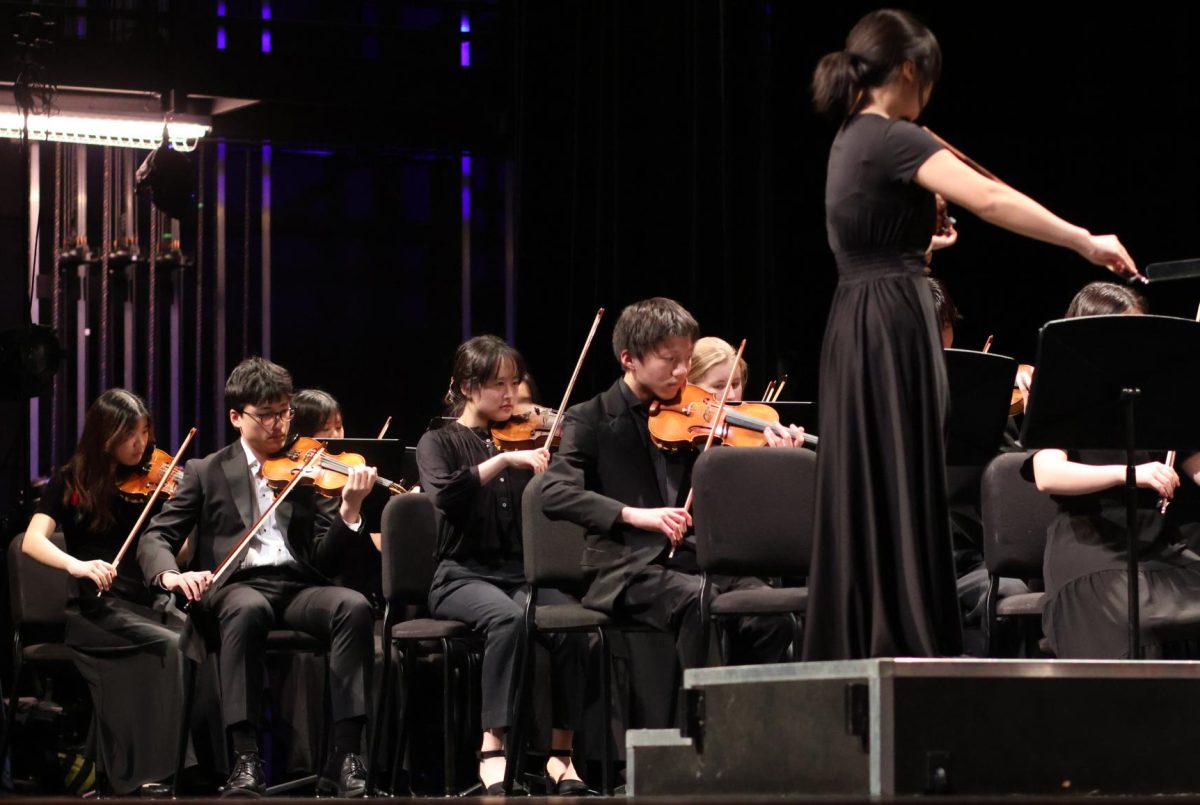 With precision, Lerchen Zhong '26 delves into Claire de Lune by Claude Debussy alongside the All-Region Symphony Orchestra. The award-winning orchestra received a standing ovation after their performance.
