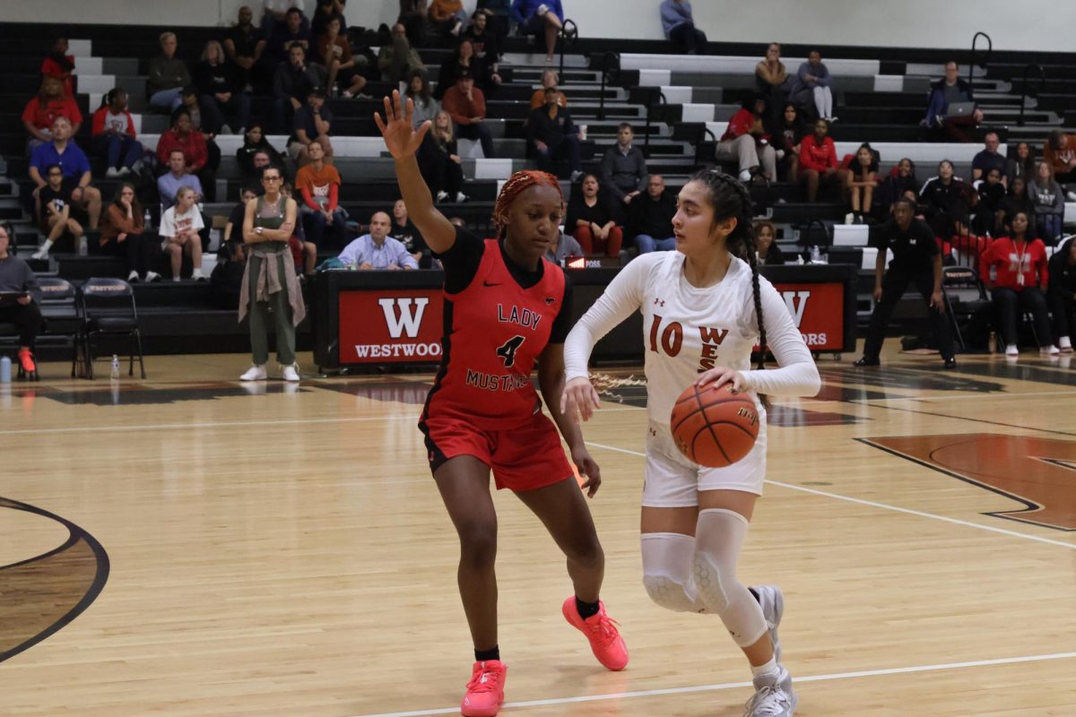 Getting ready to make a play, Isabella D'Alessandro '25 runs the ball down the court and settles down her teammates. She prepared her teammates for a motion offense which the team worked on all week in practice.