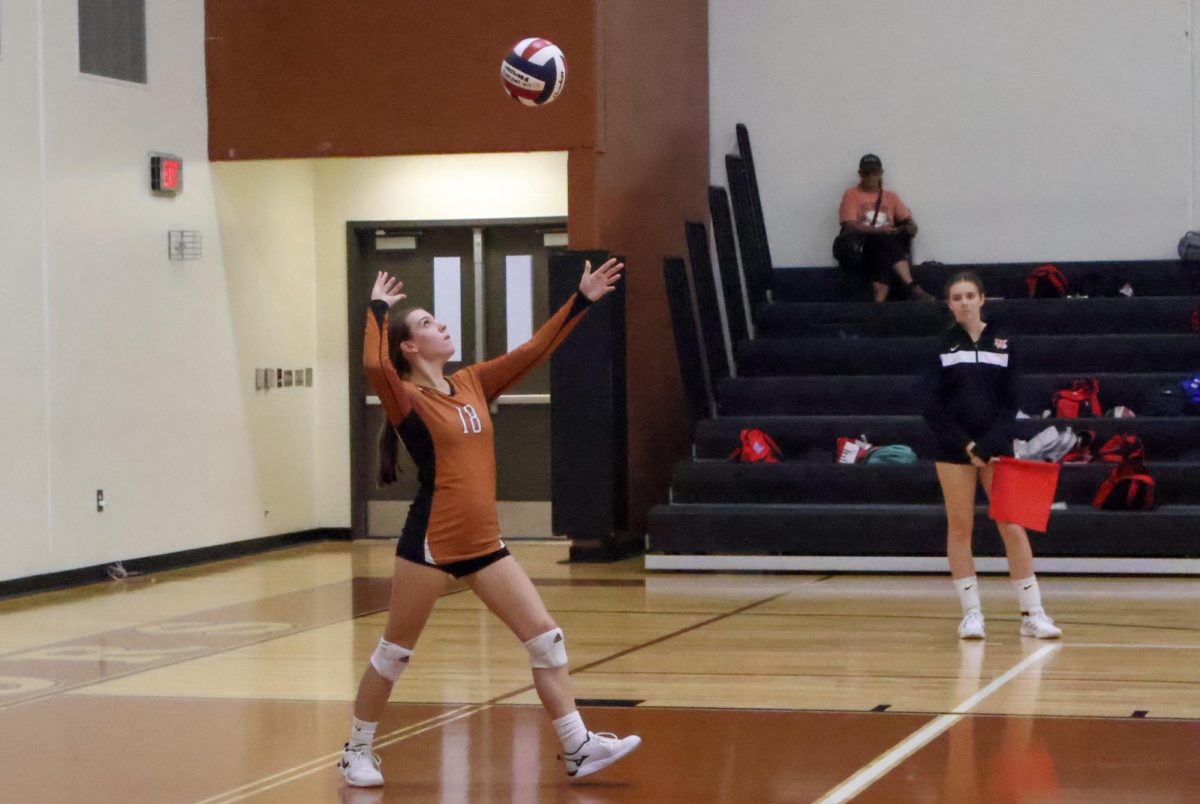 Madelyn Ivy '27 serves the ball over the net in the second set. The warriors were trying to close the gap with their strong serves. 