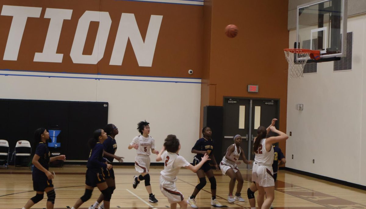 Rising for the rebound, the Warriors crowd the paint hoping for another chance at a score with a rebound. The Warriors were out-rebounded all night and allowed Stony point many second-chance points which contributed to the blow out.