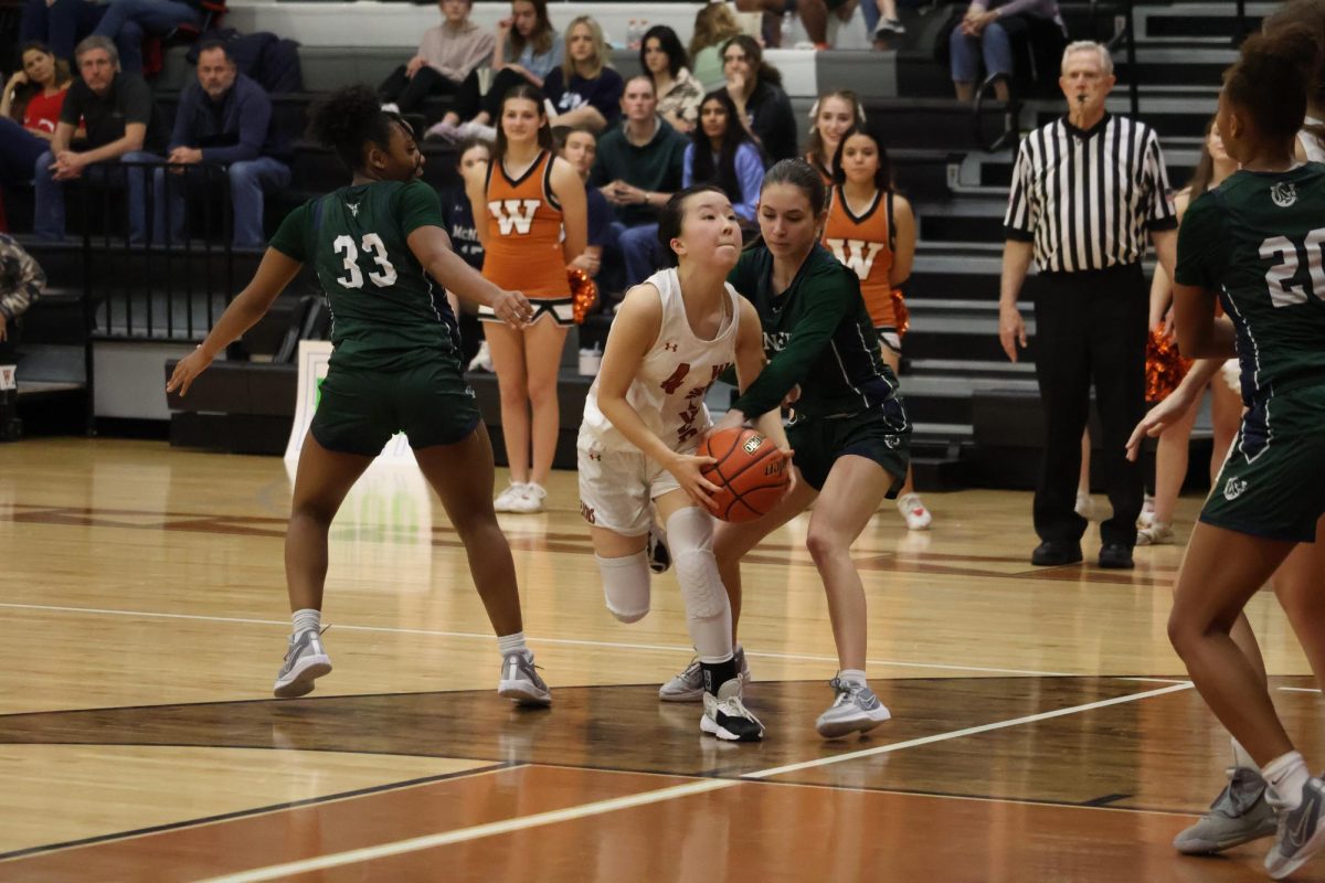 Eyes on the prize Claire Lee '26 crashes to the basket to make a basket. Lee was a huge part of the Lady Warriors offense and scored multiple baskets throughout the game.