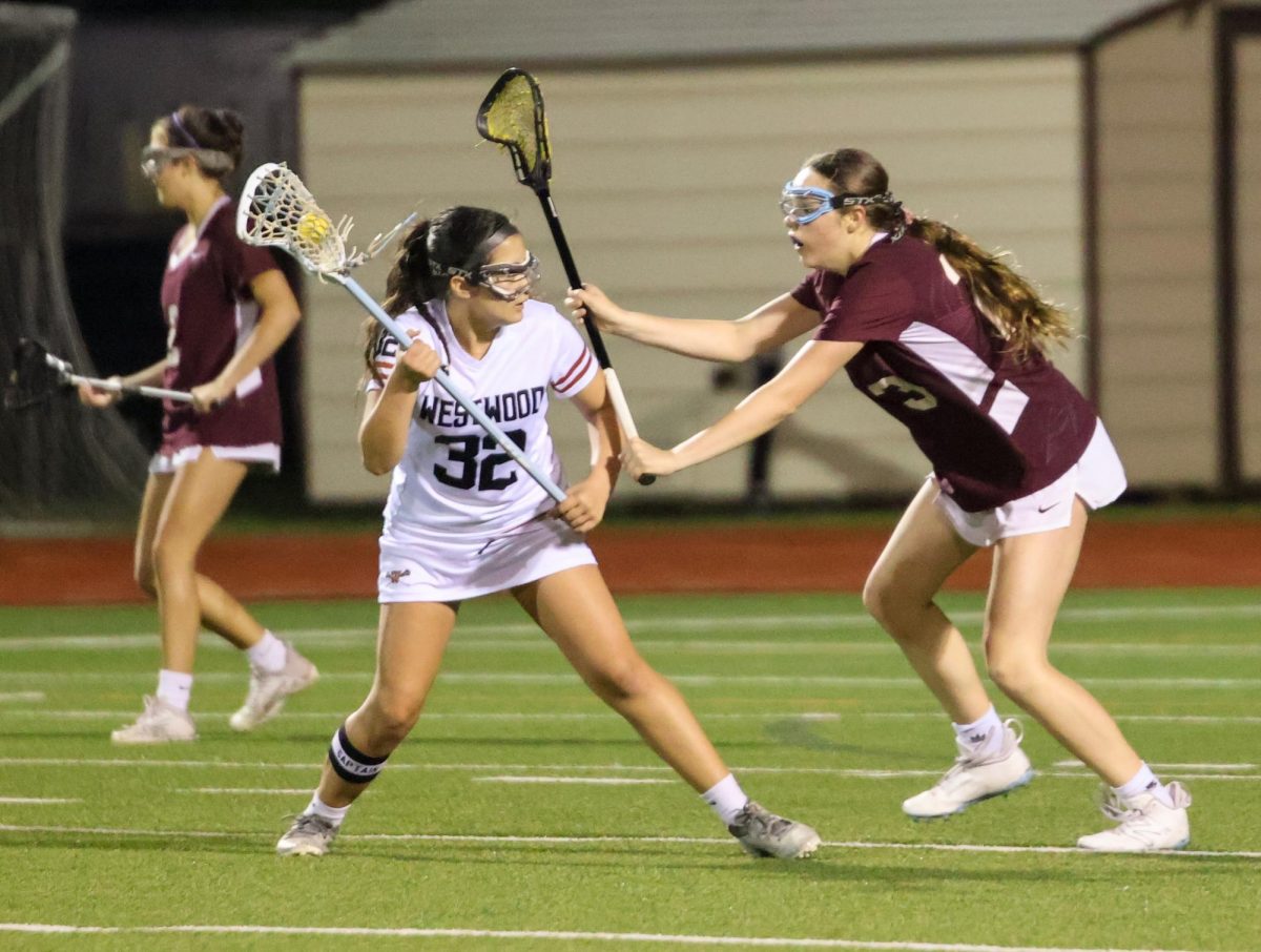 Maintaining the ball, Sara Acosta '27 swiftly dodges the attack of her opponent.  Acosta is a new player to the team and has maintained her position as an attacker throughout the entire season. "We played well in the whole game.. we fought really hard," Acosta said. 