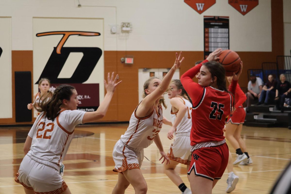 With their hands up, Holly Vessa '26 and Hope Davis '25 play tight defence on an opposing player. Because The Raiders got the defensive rebound The Warriors had to work hard and played impressive defense to attempt to get the ball back.
"Stopping the ball from getting down court quickly is super important so that we have time to set up our defense," Davis said.  