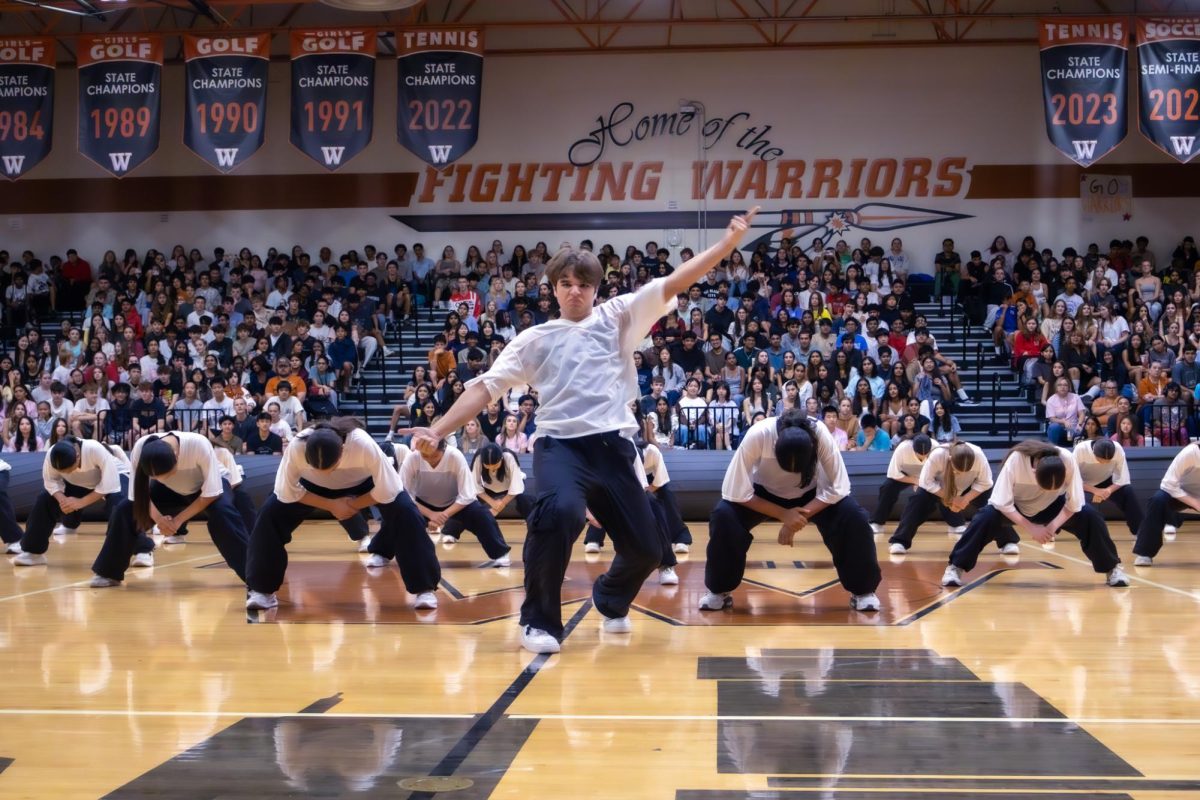 Jumping energetically, SunDancer Major Elliott Richards '26 begins the performance dynamically. The SunDancers performed to a mashup of songs.