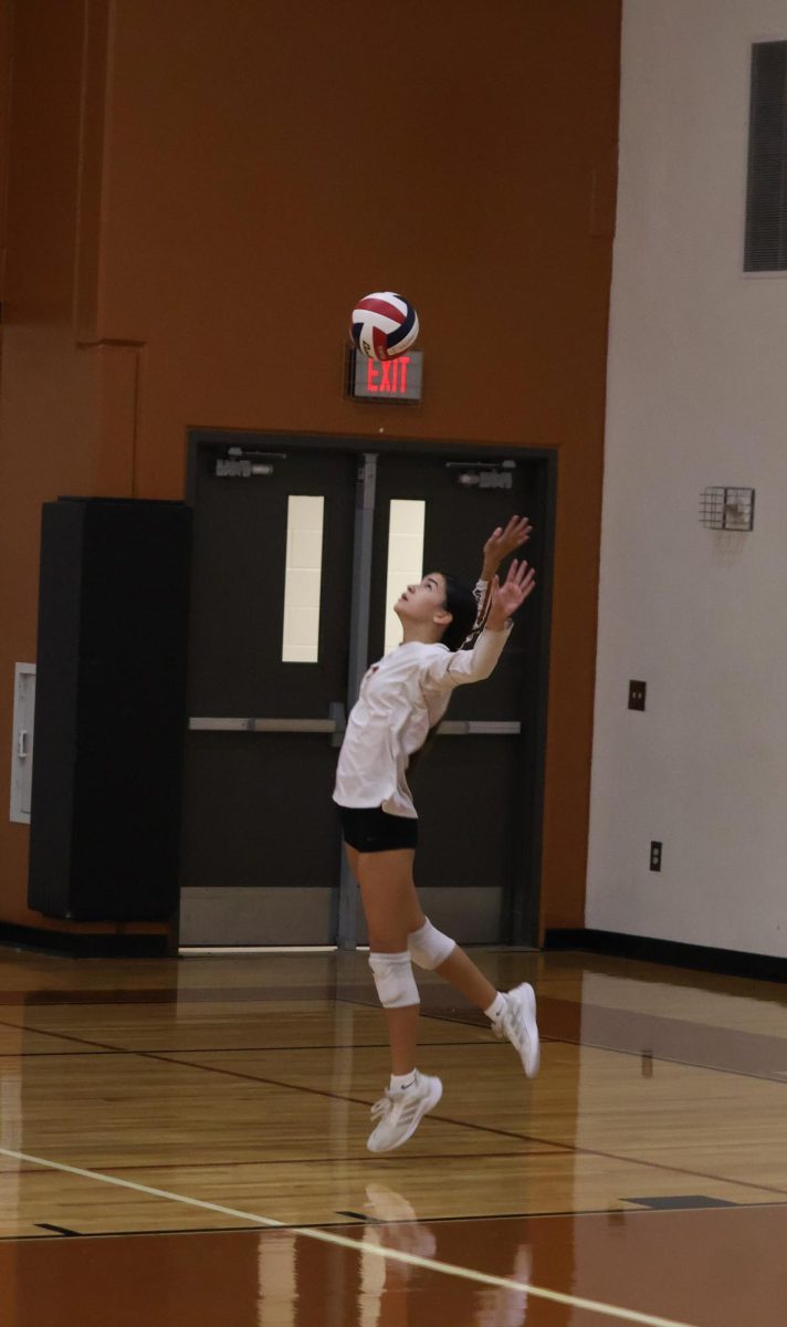 With her eyes never leaving the ball, Georgia Leuck '29 jumps to prepare for her serve. Leuck's solid serves throughout the game led to back-and-forth rallies.