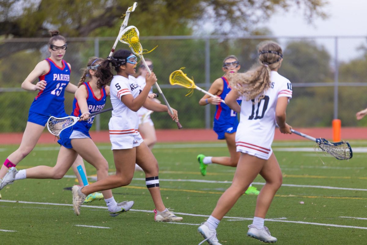 Calling to her teammates, Talia Philip '25 looks for someone open to pass to. Philip played a more casual defensive role during the game. 
