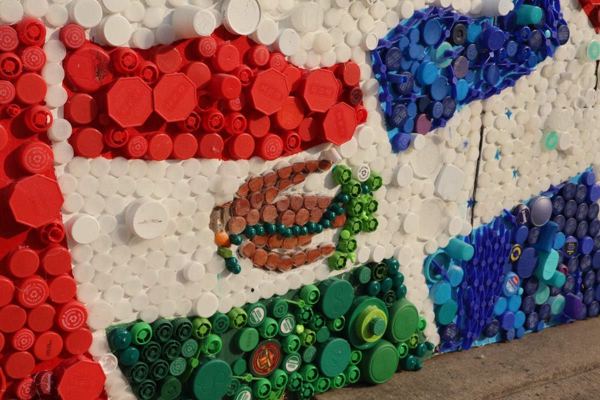 Decorated in bright red HEB lids, green juice tops, and white bottle caps, the collection of lids on the mural form the Mexican flag. Proud of their work, HSA students danced to Spanish music after speeches and awards were given.