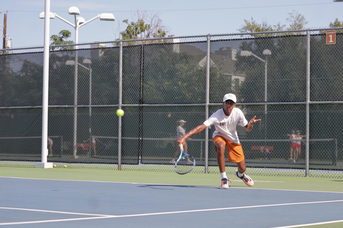 Focused and ready, Kishan Anasuri ’28 prepares to return a serve during his singles match. Having strong and steady play, he helped the warriors maintain their momentum in the matchup.