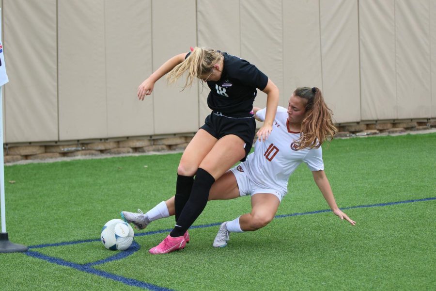 Keeping her foot on the ball to defend, Mia Wiele '26 focuses on her play. Wiele tried hard to keep the ball in bounds so that the standoff would not result in a corner kick for the other team.