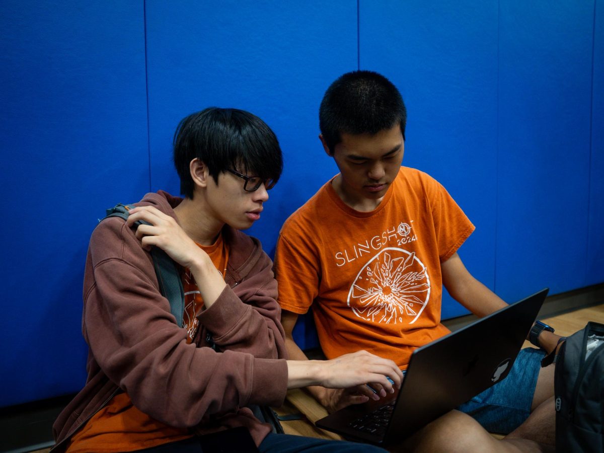Focused, seniors James Tam and Jining Liu discuss long-awaited scoring information disclosed at the kickoff. As primary developers of the FTC Scorer App, they hoped to update their user interface and experience as soon as possible to match the new game. 