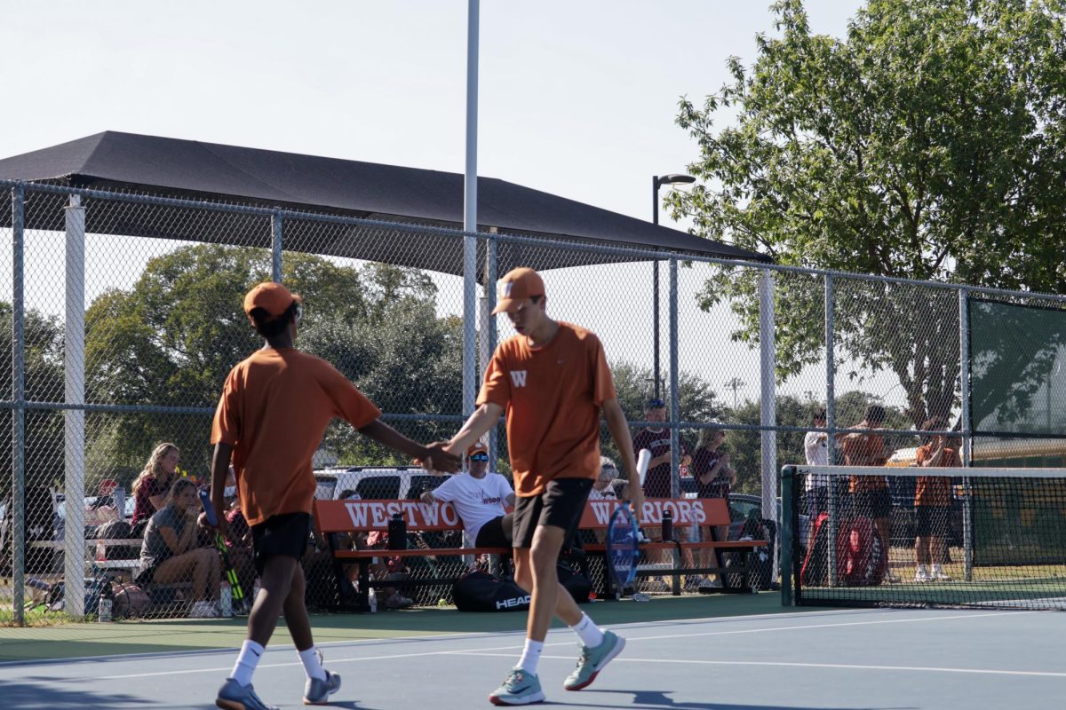 After a successful point, Jensen Hare' 27 and Ananth Sridhar '27 exchange a high five on the court. 