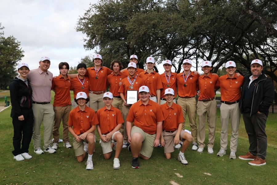 After a long tournament, the boys who competed gather for a picture with their awards on display.