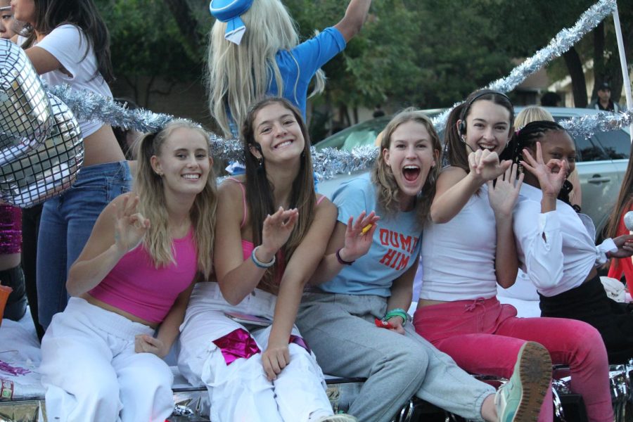 Terin Score '23, Allie Shepard '23, Claire Delane '23, Julia Hopkins '24, and Trinity Woods '23 wave from the front of the volleyball team's float. The float's theme was Britney Spears. 