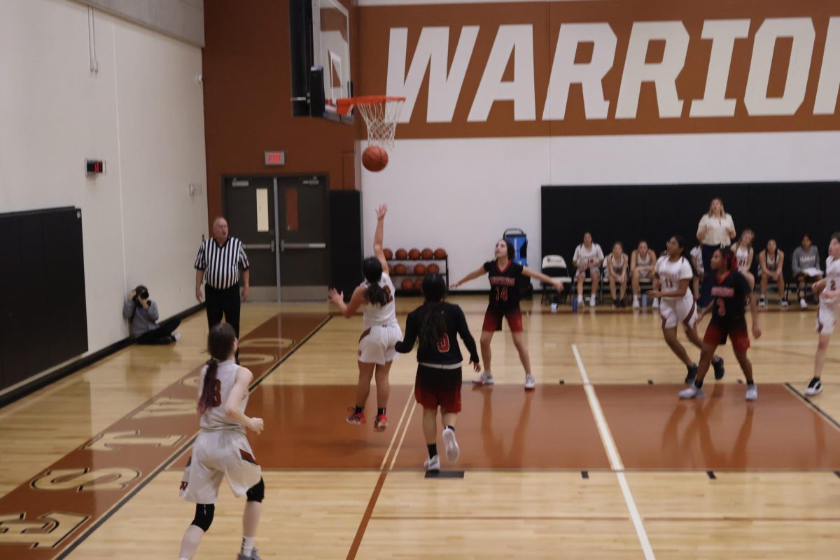 Putting up a shot, Maya Alas '27 makes the free throw putting the Lady Warriors in the lead. The Warriors gained a large lead over the Mustangs with the end result having a 10 point score gap. 