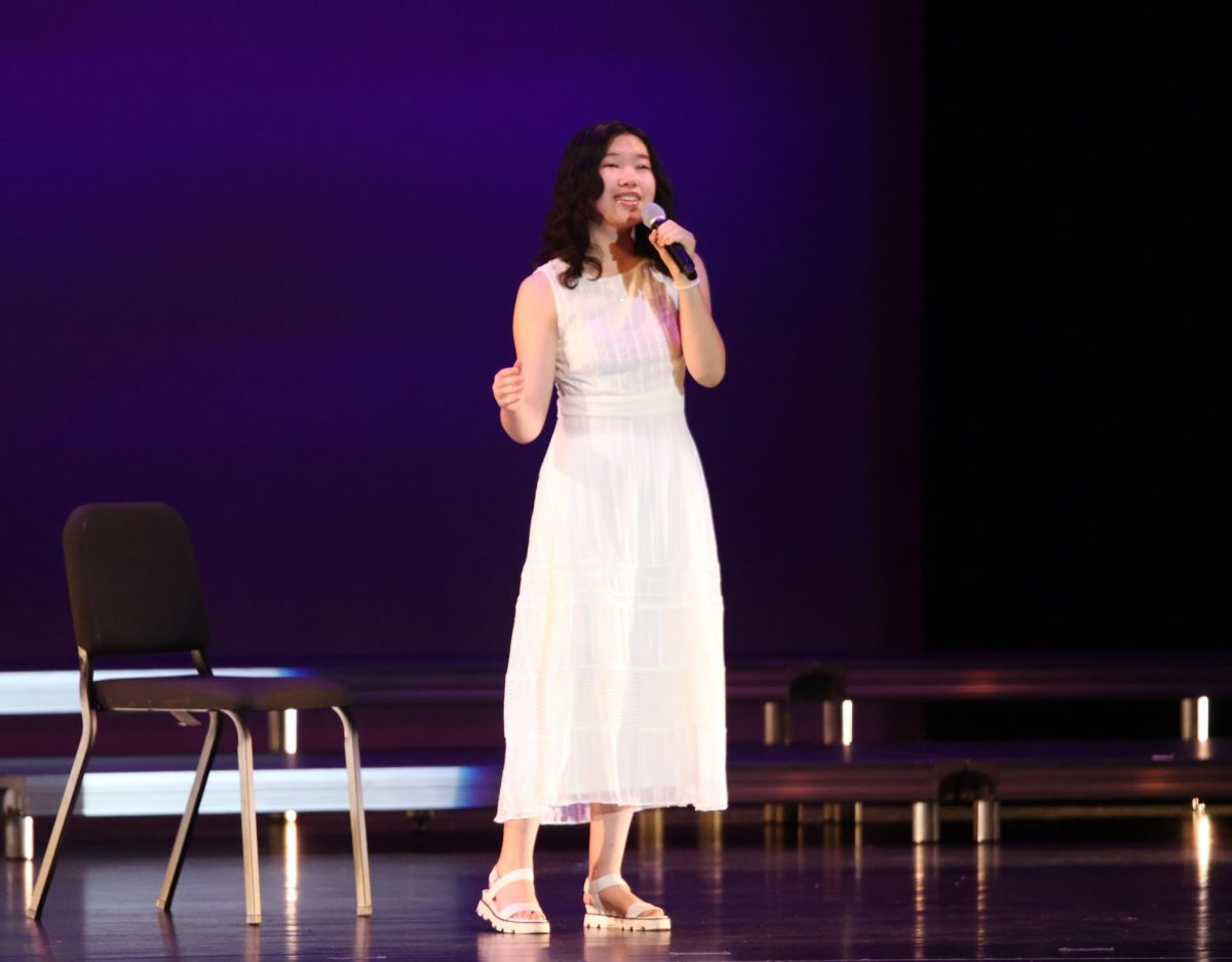 On the PAC stage, Kalia Wang '26 performs a verse from her duet with Ryan Gu '26. The duo performed 'Both Sides Now' by Joni Mitchell, and the Playlist performance marked their third year in a row performing duets at end-of-year concerts.
