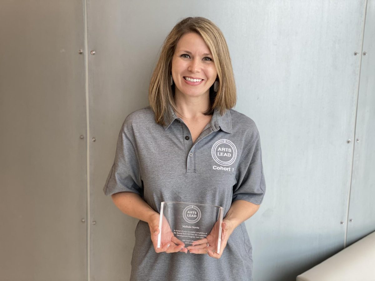 Posing, Mrs. Norris smiles for a photo. Beginning her second year as a testing coordinator, Mrs. Norris is excited for what awaits.