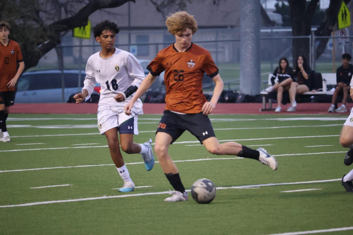 Griffin Goss '26 makes a pass across the field. Goss used good footwork and long passes to get around the Mavericks and the ball down the line. 