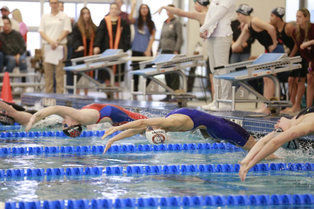 Arching back, Namanh Truong '26 starts off the 200-Yard-Medley Relay. Westwood Girls clutched first place in this event. 