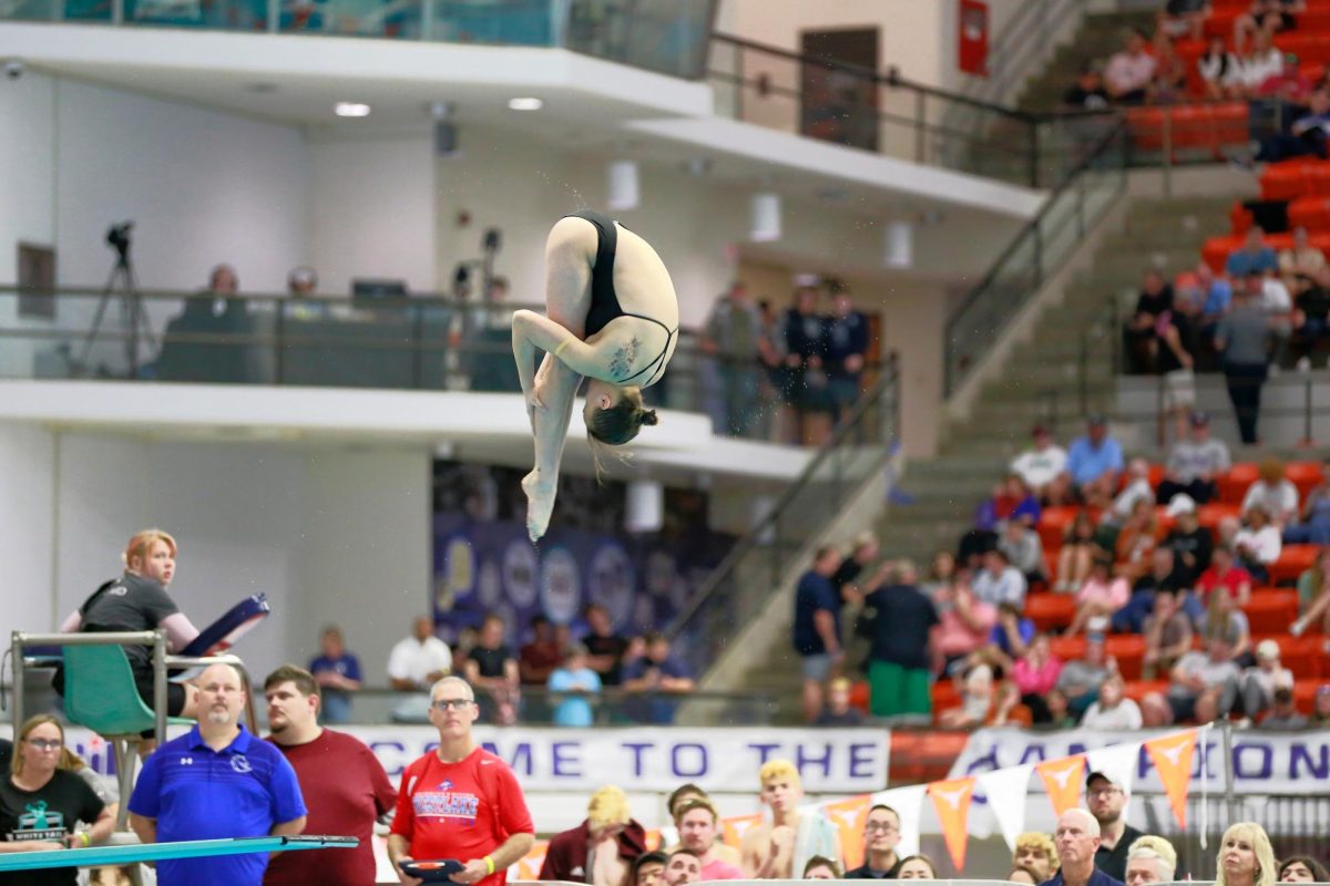 Tucking her head tightly against her knees, Jazzlyn Vaughan '26 performs her routine dive. As a sophmore, Vaughan is Coach McBrearty's first State Qualifier in Diving and is looking forward to expanding her success in the next two years. “It’s kinda crazy,” Vaughan said. “I’m just in shock and it just makes me so excited and proud of myself.”
