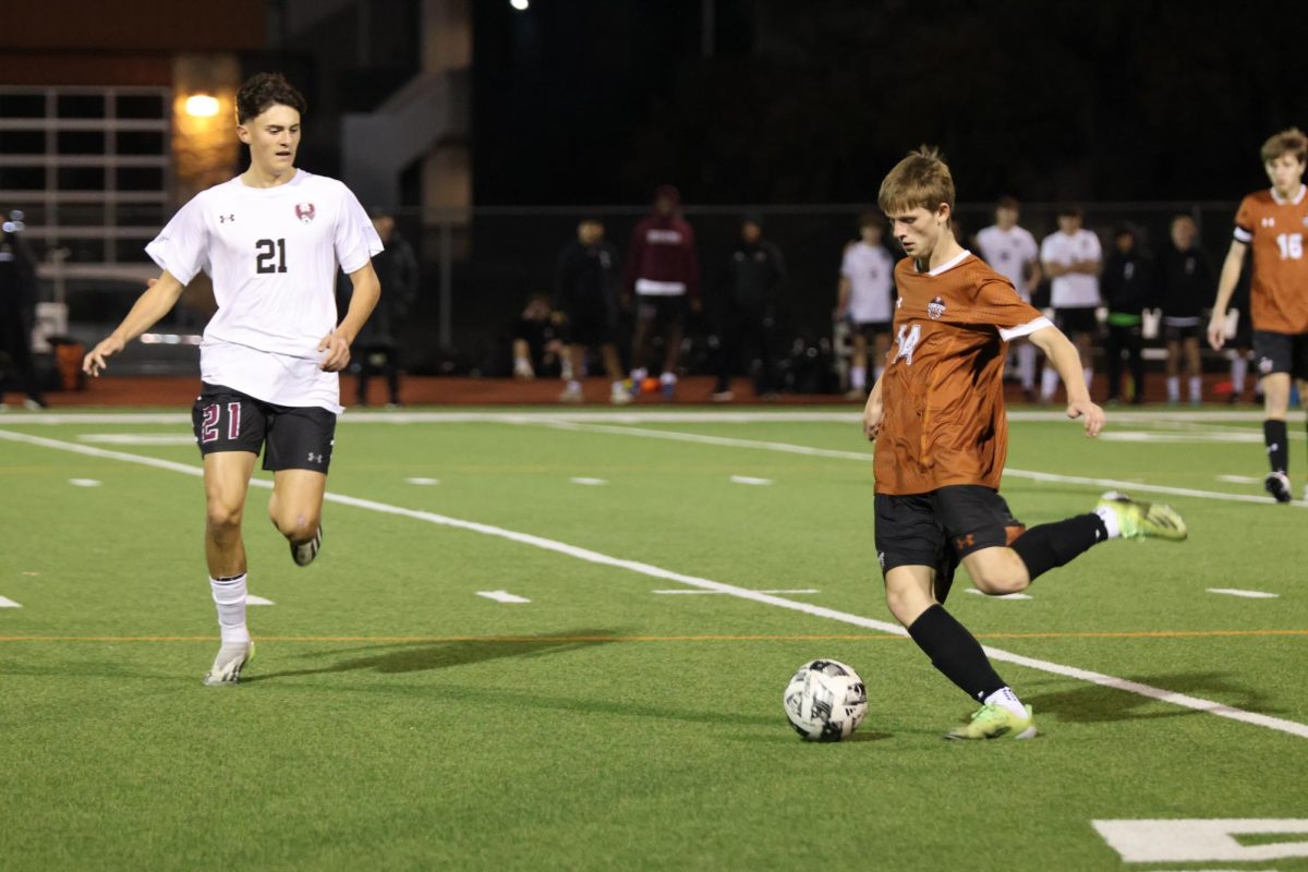 Jack Cox ‘26 kicks the ball to an open teammate. During the game, Cox proved that he was essential to the team by scoring a point for Westwood and executing skilled plays.
