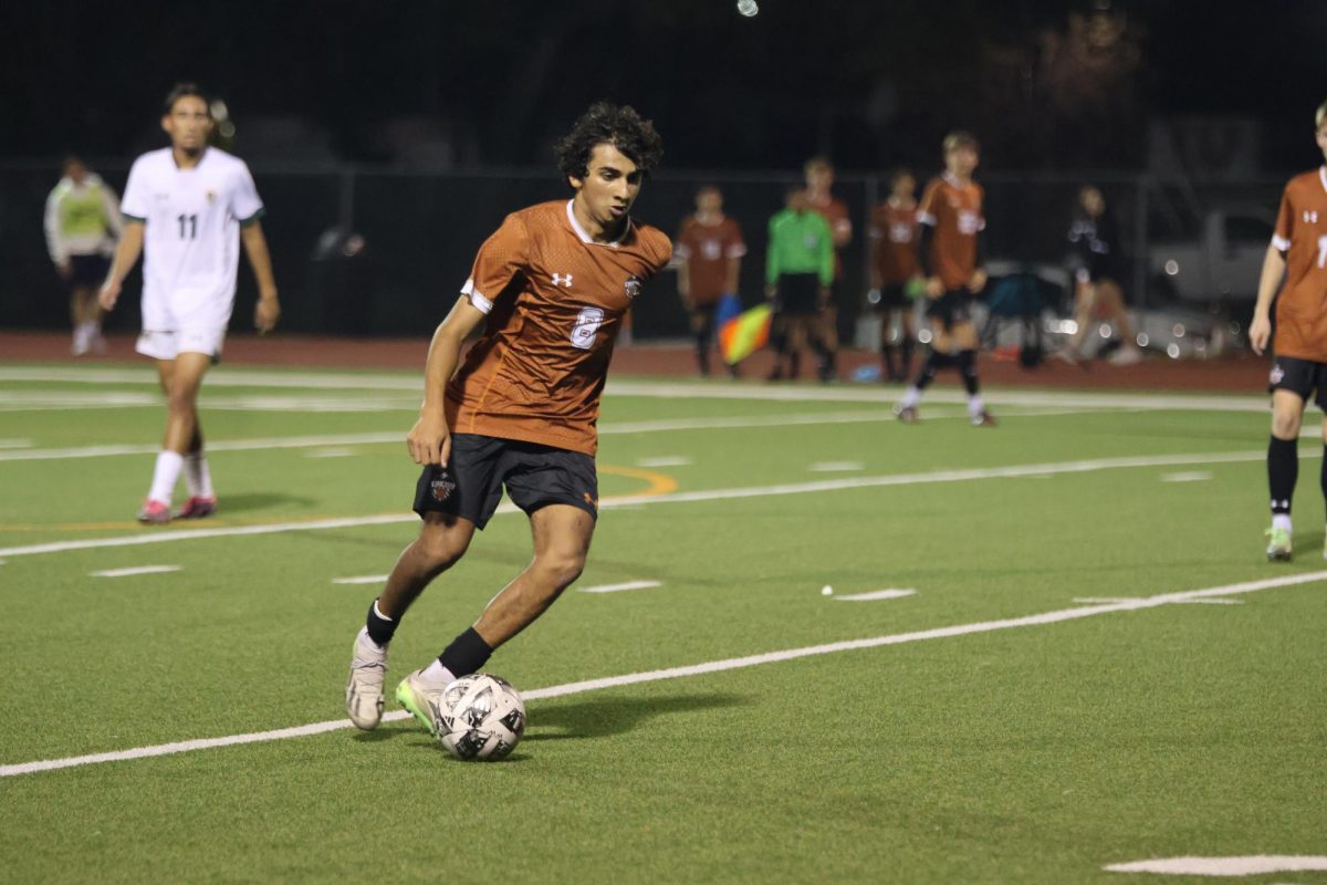 Moving the ball up the field, Ishaan Saini ‘26 focuses intently on keeping possession of the ball. For most of the game, possession switched between the Warriors and the Mavericks, so Saini was intent on keeping the ball on offense. 