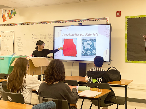 During the seventh meeting hosted by The Fiber Arts Club, Treasurer Joy Kim ‘26 presents a slideshow teaching club members. Every week, the club updates members about fiber art terms, gives announcements, and takes attendance before the meeting. “I talked about the difference between stockinette and fair isle knitting to teach the beginners basic knitting terminology," Kim said. "Announcements [covered] our future events and charities we will be working with very soon.”
