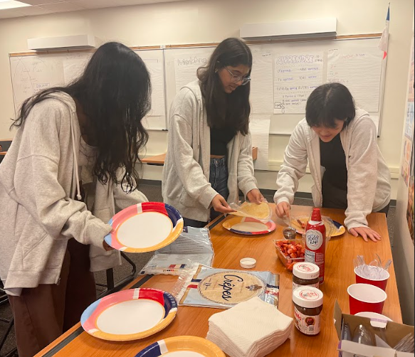 Concentrated, sophomores Ojasvi Chourasia, Isha Gokhale, and Bella Yi make themselves crepes. The main focus of the meeting, the officer team created a build-your-own crepe station for members to enjoy. “[The best part of today’s meeting were] the crepes, they were delicious,” member Brady Johnson ‘26 said. 