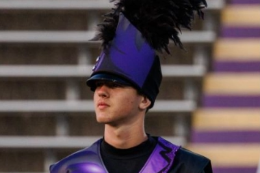 Waiting for the show to begin, Alexander Broyles '25 stances at standby. Last summer, Broyles marched a season with Genesis, a world-class drum-corp. “It was nerve-racking standing in the field before a show, but really you're so focused on making the run as good as possible that you don't really notice the thousands of people watching you,” Broyles said.