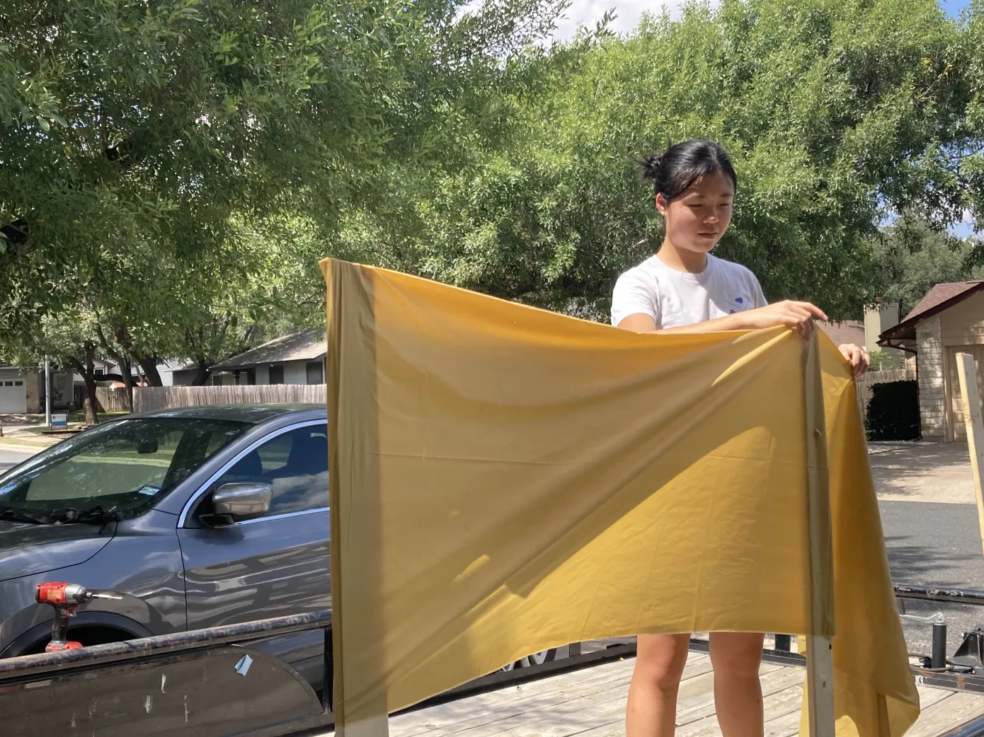 Tying the project together, Student Council (StuCo) Junior Class President Nancy Lu fastens gold fabric onto the float. The StuCo Junior Class was inspired by the song ‘24K Magic' by Bruno Mars to create a gold-themed float. "We picked lots of gold garlands and streamers to make our float pop and give it a fun vibe," Lu said. "They represent money as according to ‘24Karat [Magic]'."